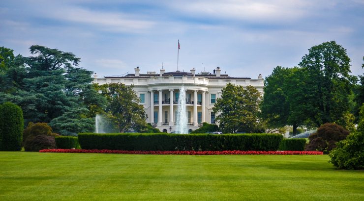 The outside, front view of the White House and some of it's landscaping features